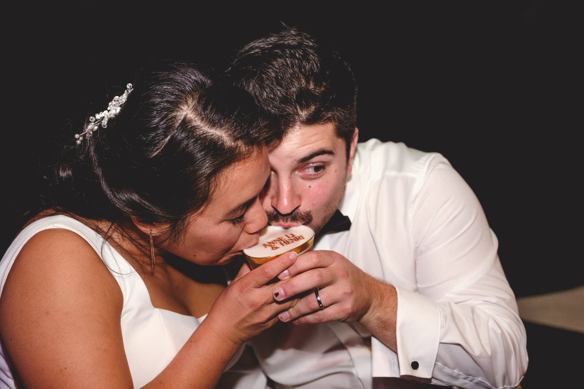 Mariés partageant un cocktail avec leurs prénoms imprimés sur la mousse